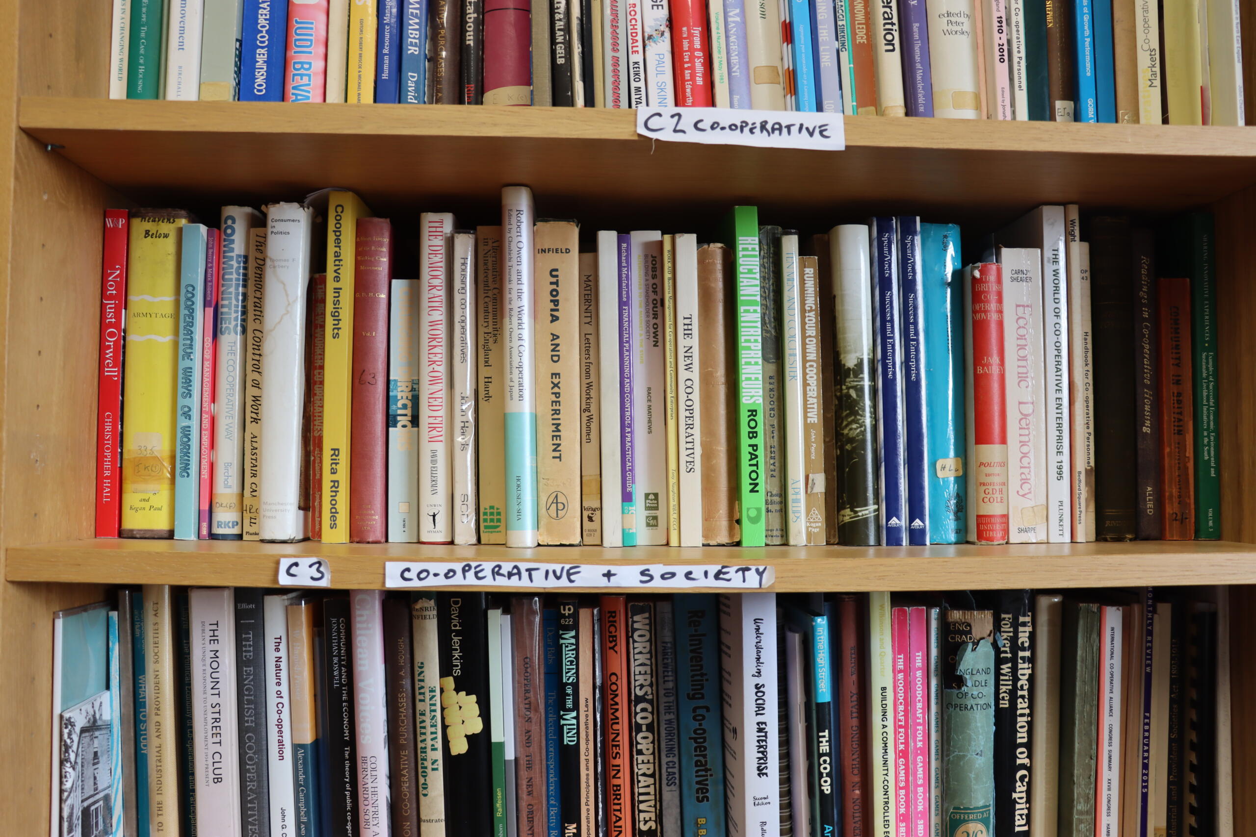 Shelves of co-operative books in the Principle 5 library